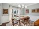 Mid-century modern dining room with hardwood floors and large windows at 8720 Tamarron Dr, Charlotte, NC 28277