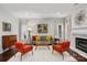 Living room featuring hardwood floors, fireplace, and mid century modern furniture at 8720 Tamarron Dr, Charlotte, NC 28277