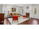 Living room featuring hardwood floors, fireplace, and mid century modern furniture at 8720 Tamarron Dr, Charlotte, NC 28277