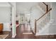 Hardwood floor entryway with white staircase and view of living room at 8720 Tamarron Dr, Charlotte, NC 28277