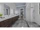 Elegant bathroom with marble tile, dual vanity, and large walk-in shower at 8928 Heydon Hall Cir, Charlotte, NC 28210