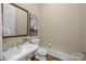 Classic powder room with white sink, dark wood floors, and framed art at 8928 Heydon Hall Cir, Charlotte, NC 28210