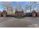 Elegant brick entrance with wrought iron gates, surrounded by lush landscaping at 8928 Heydon Hall Cir, Charlotte, NC 28210