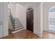 Elegant entryway with hardwood floors and a grand staircase at 8928 Heydon Hall Cir, Charlotte, NC 28210