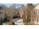 Traditional two-story brick house with a circular driveway and well-maintained landscaping at 8928 Heydon Hall Cir, Charlotte, NC 28210