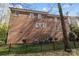 Exterior view of a brick house featuring a fenced backyard and visible air conditioning units at 8928 Heydon Hall Cir, Charlotte, NC 28210