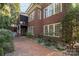 Charming brick home showcasing a brick patio, screened porch and manicured landscaping at 8928 Heydon Hall Cir, Charlotte, NC 28210