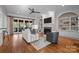 Open living space with built-in shelving and hardwood floors at 8928 Heydon Hall Cir, Charlotte, NC 28210