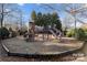 Community playground featuring play structures, slides, and climbing equipment in a fenced area at 8928 Heydon Hall Cir, Charlotte, NC 28210