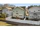 View of the light green two-story home featuring a fenced backyard at 907 Millbrook Rd, Charlotte, NC 28211