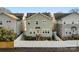 The light green two-story home has a fenced backyard with a small deck at 907 Millbrook Rd, Charlotte, NC 28211