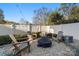 Outdoor fire pit area with Adirondack chairs and pea gravel at 907 Millbrook Rd, Charlotte, NC 28211