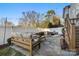 Backyard patio with sofa, chairs, a fire pit, pea gravel, string lights, and landscaping at 907 Millbrook Rd, Charlotte, NC 28211