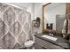 Stylish bathroom featuring a modern vanity, patterned shower curtain, and wood-framed mirror at 907 Millbrook Rd, Charlotte, NC 28211