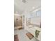 Bright bathroom featuring a soaking tub, glass-enclosed shower, and neutral tile at 907 Millbrook Rd, Charlotte, NC 28211