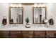 Elegant bathroom featuring dual sinks, wooden framed mirrors, and stylish fixtures at 907 Millbrook Rd, Charlotte, NC 28211