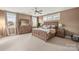 Spacious bedroom with neutral carpet, large bed, dresser, and ample natural light at 907 Millbrook Rd, Charlotte, NC 28211