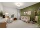 Neutral Bedroom design featuring an accent wall and comfortable furniture at 907 Millbrook Rd, Charlotte, NC 28211