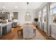 Dining area with stainless steel appliances, wooden dining table, natural light and hardwood floors at 907 Millbrook Rd, Charlotte, NC 28211