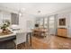 Bright dining area with a wooden table, bench seating, pendant lighting and views to the backyard at 907 Millbrook Rd, Charlotte, NC 28211