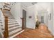 Inviting entryway with hardwood floors, staircase, and access to other rooms in the house at 907 Millbrook Rd, Charlotte, NC 28211