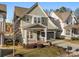 Attractive two-story home with a front porch, neatly landscaped yard, and a two-car garage at 907 Millbrook Rd, Charlotte, NC 28211