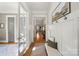 Bright hallway with hardwood floors and elegant wall decor leading to other rooms at 907 Millbrook Rd, Charlotte, NC 28211