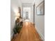 Hallway featuring hardwood flooring and neutral wall colors, creating a warm and inviting ambiance at 907 Millbrook Rd, Charlotte, NC 28211