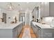 Bright and open kitchen with stainless steel appliances, a large island with breakfast bar, and hardwood floors at 907 Millbrook Rd, Charlotte, NC 28211