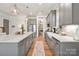 Bright and open kitchen with stainless steel appliances, a large island with breakfast bar and butler's pantry at 907 Millbrook Rd, Charlotte, NC 28211