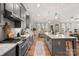 Spacious kitchen featuring stainless steel appliances, light gray cabinets, and an island with marble countertop at 907 Millbrook Rd, Charlotte, NC 28211