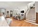 Bright and airy living room with a fireplace, TV, access to the dining and staircase at 907 Millbrook Rd, Charlotte, NC 28211