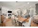 Open-concept kitchen, dining and living area with plenty of natural light, hardwood floors, and modern décor at 907 Millbrook Rd, Charlotte, NC 28211