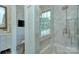 Bathroom featuring a walk-in shower, built-in bench, and large window at 961 Jw Wilson Rd, Fort Mill, SC 29715