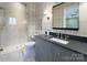 Modern bathroom with gray vanity, gray-tiled shower, and stylish fixtures at 961 Jw Wilson Rd, Fort Mill, SC 29715