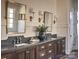 Double vanity bathroom with dark wood cabinets and gold accents at 961 Jw Wilson Rd, Fort Mill, SC 29715