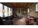 Stylish living room with built-in bookshelves, fireplace, wood ceiling, and leather couch at 961 Jw Wilson Rd, Fort Mill, SC 29715