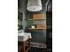 Charming powder room featuring a pedestal sink, wood paneled walls and floating shelves at 961 Jw Wilson Rd, Fort Mill, SC 29715