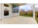Covered back patio with access door and view of wooded area at 1033 Merganser Way, Indian Trail, NC 28079
