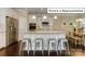 Open kitchen features an island, stainless steel appliances, and dark hardwood floors at 1033 Merganser Way, Indian Trail, NC 28079