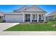 New construction home with gray siding, white trim, and a landscaped lawn at 110 Sari St, Troutman, NC 28166
