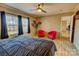 Relaxing main bedroom with two red accent chairs and large windows at 1301 Brandy Ln # 7, Shelby, NC 28152