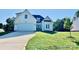 Cream-colored two-story home boasting a lush green lawn, an attached two-car garage and a welcoming front entrance at 136 Autumn Blaze Rd, China Grove, NC 28023