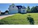 Charming cream-colored, two-story home with a well-manicured lawn and attached two-car garage at 136 Autumn Blaze Rd, China Grove, NC 28023
