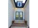 Charming front entrance boasts double doors framed by decorative flower pots and miniature American flags at 136 Autumn Blaze Rd, China Grove, NC 28023
