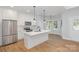 Modern kitchen featuring white cabinets, quartz countertops, and stainless steel appliances at 136 Autumn Blaze Rd, China Grove, NC 28023