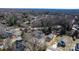 Aerial view highlighting a new house in a neighborhood with mature trees and surrounding landscape at 140 3Rd Se Ave, Hickory, NC 28602