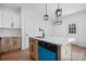 Modern kitchen with island, blue dishwasher, and white shaker cabinets at 140 3Rd Se Ave, Hickory, NC 28602
