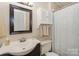 Cozy bathroom featuring a vanity with sink, mirror, medicine cabinet, toilet and shower with curtain at 170 Woodcrest Rd, Mooresville, NC 28115