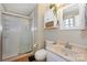 Well-lit bathroom with toilet, vanity, medicine cabinet, and glass-enclosed shower stall at 170 Woodcrest Rd, Mooresville, NC 28115
